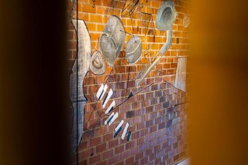 a brick wall with a painting of toilets on it at ART LOFTS Valencia by Benisur in Valencia