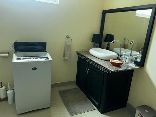 a bathroom with a sink and a mirror at Blue sea in Baie du Cap