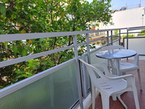 a patio with two chairs and a table on a balcony at Bristol Apartments in Kos Town