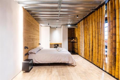 a bedroom with a bed in a room with wooden walls at ART LOFTS Valencia by Benisur in Valencia