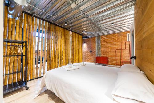 a bedroom with a large white bed in a room at ART LOFTS Valencia by Benisur in Valencia