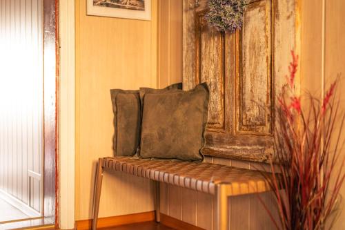 a bench with two pillows on it in a room at OderPoint#Sauna#Jacuzzi in Gozdowice
