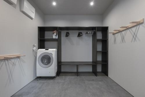 a laundry room with a washing machine in it at Hakuba Hibiku Chalet by Jade Group in Hakuba