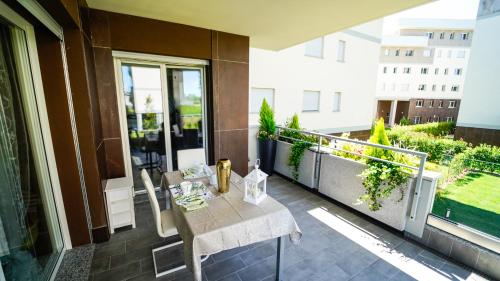 a balcony with a table on top of a building at New Living Milano in Gorgonzola
