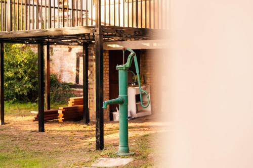 a playground with a green pipe next to a building at OderPoint#Sauna#Jacuzzi in Gozdowice