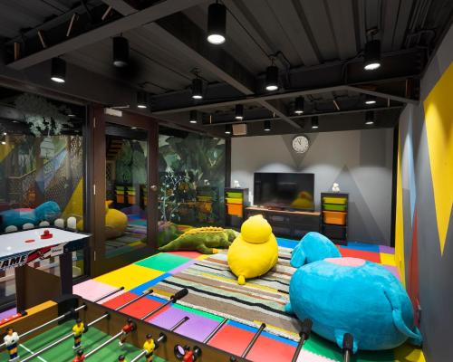 a play room with a yellow rubber duck sitting on a rug at The Apurva Kempinski Bali in Nusa Dua