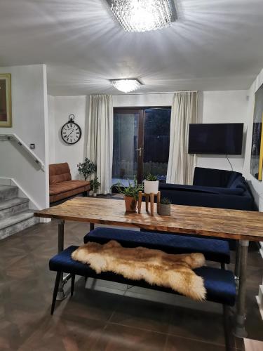 a living room with a wooden table and a couch at Riverside Cockatoo's Cottage Charming 3 Bed Retreat for up to 10 Guests in Stockton-on-Tees