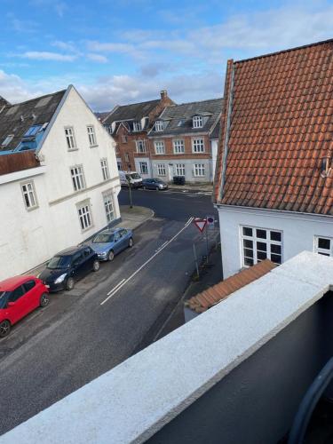 a view of a city street with cars parked on the street at Siesta Vejle in Vejle