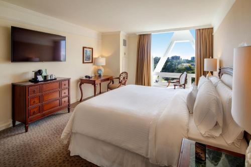 a hotel room with a bed and a large window at The Westin Camino Real, Guatemala in Guatemala