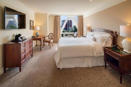 a hotel room with a bed and a desk and a desk at The Westin Camino Real, Guatemala in Guatemala