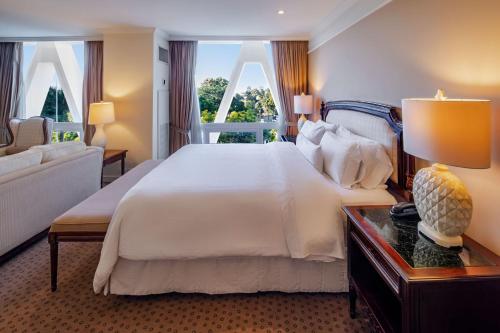 a bedroom with a large white bed and a window at The Westin Camino Real, Guatemala in Guatemala
