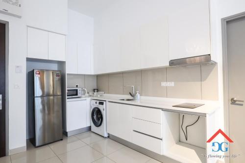 a white kitchen with a refrigerator and a dishwasher at Astoria Ampang By Grabstay in Kuala Lumpur