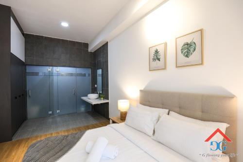 a bedroom with a white bed and a bathroom at Astoria Ampang By Grabstay in Kuala Lumpur