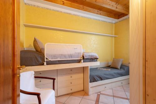 a room with a bed and a laptop on a desk at Residence Garda Sole 3-69 by Wonderful Italy in Padenghe sul Garda