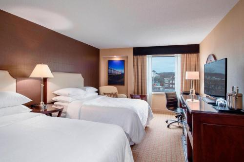 a hotel room with two beds and a desk at Sheraton Hotel Newfoundland in St. John's