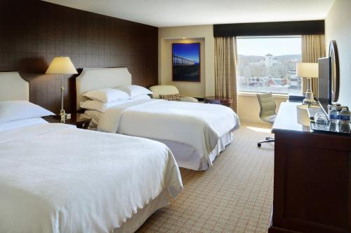 a hotel room with two beds and a television at Sheraton Hotel Newfoundland in St. John's