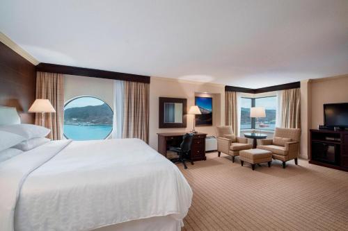 a hotel room with a bed and a large window at Sheraton Hotel Newfoundland in St. John's