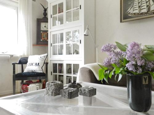 a living room with a vase of purple flowers on a table at Holiday Home Sörkila in Lysekil