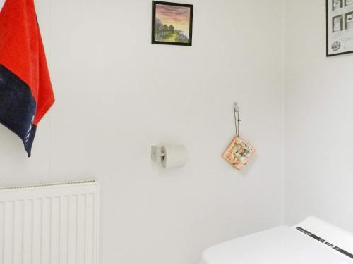 a white room with a toilet and a flag on the wall at Holiday Home Sörkila in Lysekil