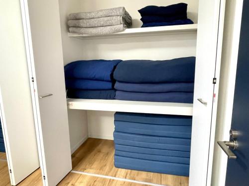 a closet with blue pillows and towels at BEACH HOUSE Kamogawa - Vacation STAY 64005v in Kamogawa