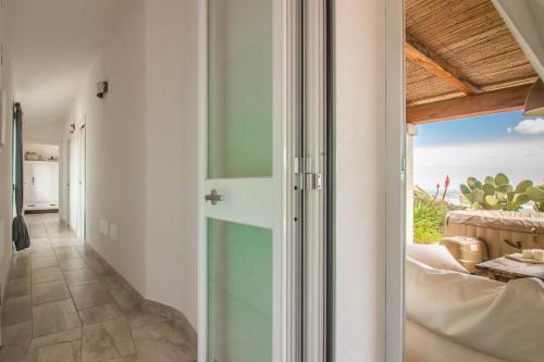 a room with a glass door with a view of the ocean at Breathtaking Villa with Dependance! in Casagliana