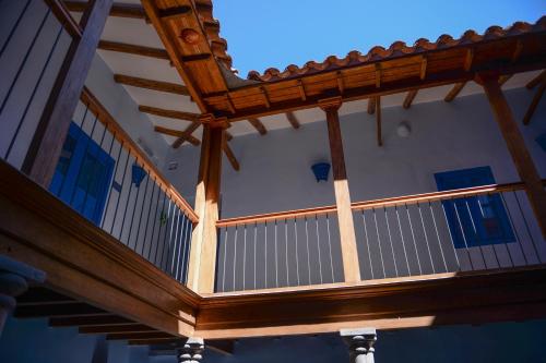 a wooden deck of a house with a roof at Quinta San Blas by Ananay Hotels in Cusco