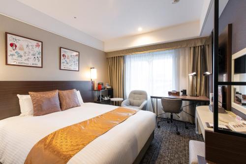 a hotel room with a bed and a desk at Kyoto Yamashina Hotel Sanraku in Kyoto