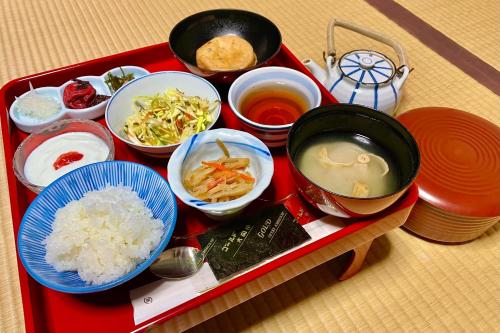 a tray of food with rice and bowls of food at Koyasan Shukubo Yochiin in Koyasan