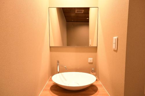 a bathroom with a large white sink in a room at Koyasan Shukubo Yochiin in Koyasan