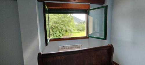 una ventana en una habitación con un banco delante en Villa Urdaibai, en Busturia