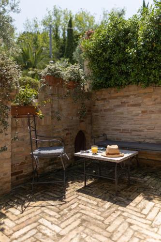 a table and a chair sitting on a patio at Villa Cri Cri B&B di Charme in San Benedetto del Tronto