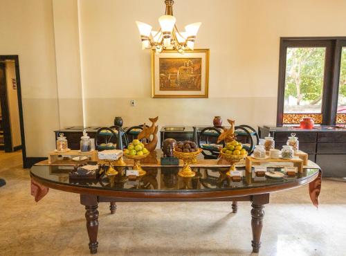 a table with bowls of fruit on it in a room at The Ayodya Palace in Nusa Dua