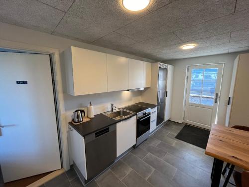a kitchen with a sink and a stove top oven at Go-Sleep Bredehus in Bredsten