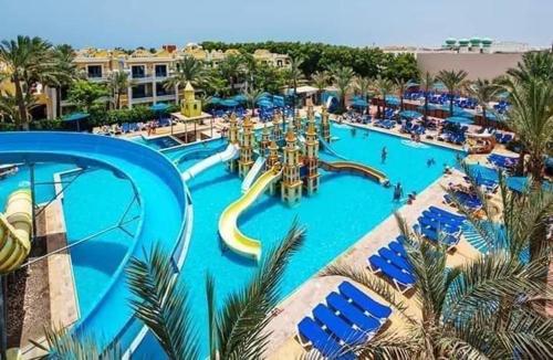 a large swimming pool with a water park at A two-room chalet in the village of Lale Land, Mirage Bay, Ecopark in Hurghada