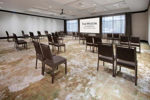 a conference room with chairs and a projection screen at The Westin Dallas Stonebriar Golf Resort & Spa in Frisco