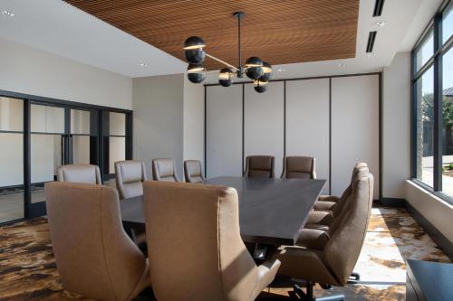 a dining room with a black table and chairs at The Westin Dallas Stonebriar Golf Resort & Spa in Frisco