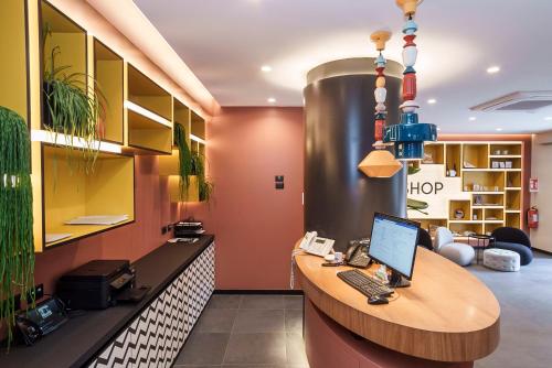 an office with a desk with a laptop on it at Aparthotel Colombo Roma in Rome