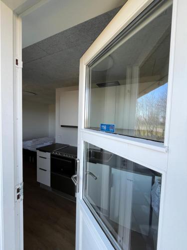 a view of a kitchen through a glass door at Go-Sleep Bredehus in Bredsten