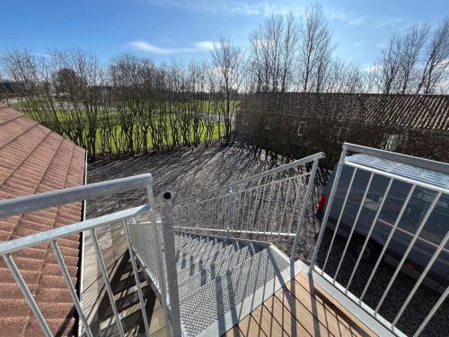 a view from the top of a balcony with a metal railing at Go-Sleep Bredehus in Bredsten