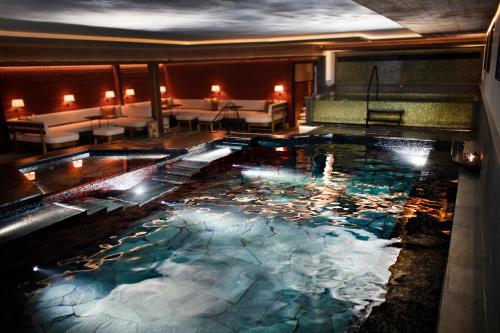a swimming pool with lights in a hotel room at Åkerblads Hotell Gästgiveri Spa in Tällberg