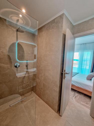 a bathroom with a shower and a glass door at My Place modern living in Kefalos
