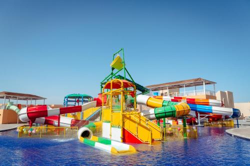 a water park with a water slide in the water at Pickalbatros Vita Resort - Portofino Marsa Alam in Abu Dabab