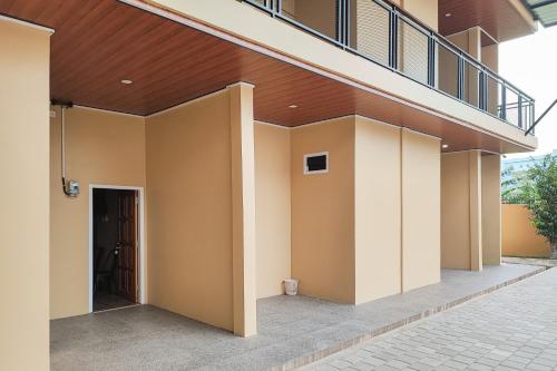 a building with a balcony and a stairway at RedDoorz Syariah near Telanaipura Jambi in Jambi