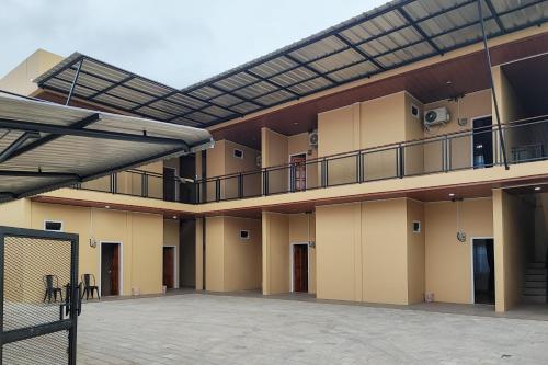 an apartment building with a balcony and a basketball court at RedDoorz Syariah near Telanaipura Jambi in Jambi