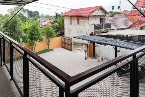 an empty balcony with a view of a city at RedDoorz Syariah near Telanaipura Jambi in Jambi