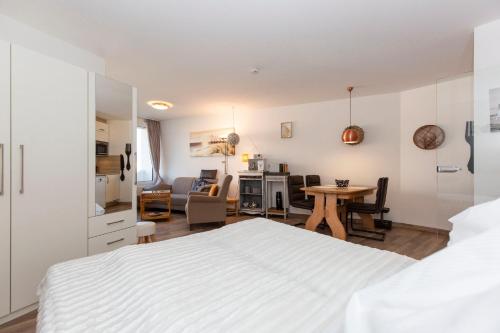 a bedroom with a bed and a living room at Lord Nelson 715 in Döse