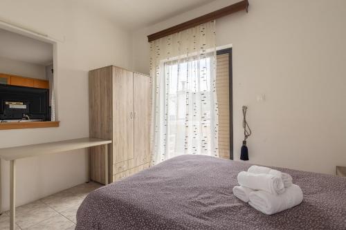 a bedroom with a bed with two towels on it at Special Apartment in Larisa