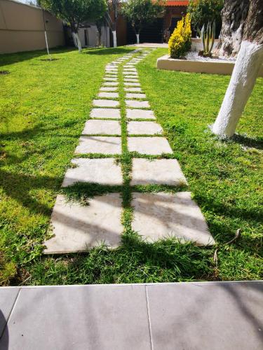 a stepping stone path in a grassy yard at Villa MATA - 600m² with Private Pool and Jacuzzi in Kalithies