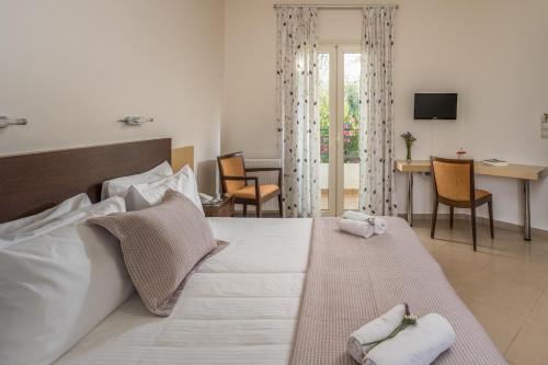 a bedroom with a large bed and a living room at Your Memories Hotel in Gouves