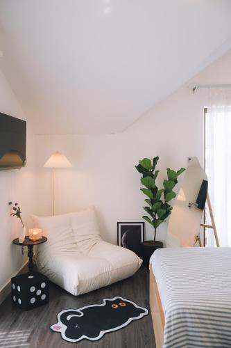 a living room with two beds and a table and a couch at Darest's Home in Da Lat